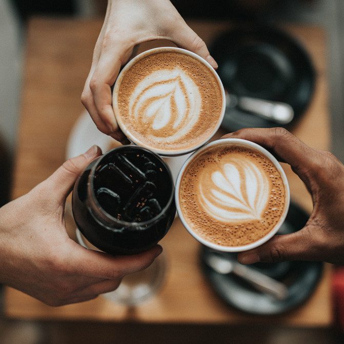 Restaurant and coffee shop, with friends cheering their glasses together. Coffee and drinks in the local neighbourhood. This area of Edmonton has many shops.