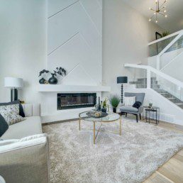 open to above great room with fireplace in the midland showhome by western living homes