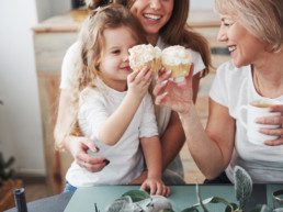 Family makes toast with cupcakes, enjoying baking in the kitchen in their brand new home in Rosewood at Secord, near Rosenthal. They found a home in Edmonton Northwest.